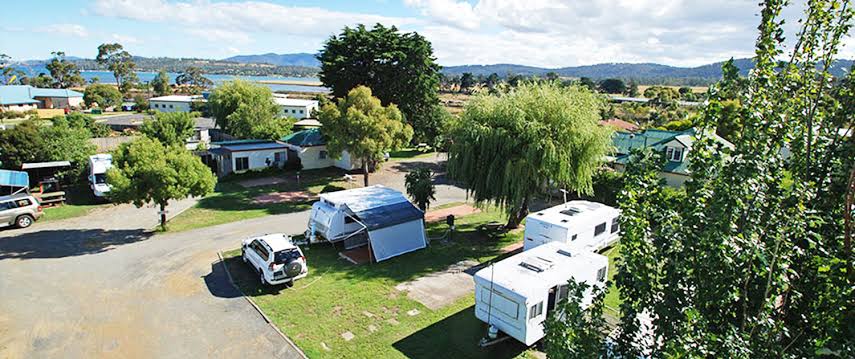 Concrete stepping stones lead to a concrete slab at the Triabunna Caravan and Cabin Accommodation