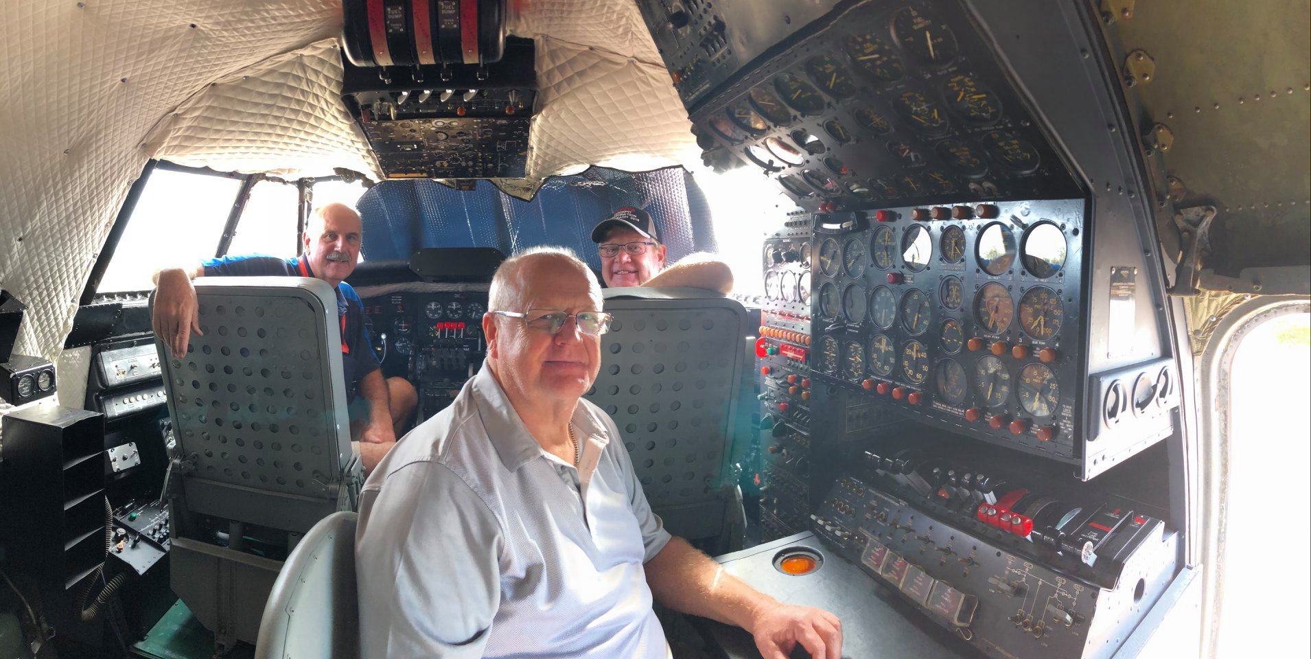 Volunteers Ray, Gerry and John inside the Super Constellation cockpit restored and home at the Qantas Founders Museum