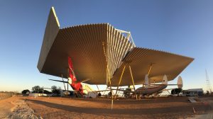 Four restored craft sheltered beneath the Airpark at sunrise at the Qantas Founders Museum